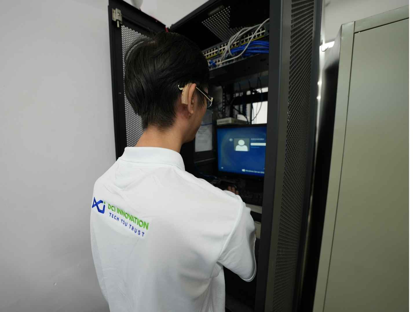 Cybersecurity specialist configuring backup systems and data encryption settings on a laptop