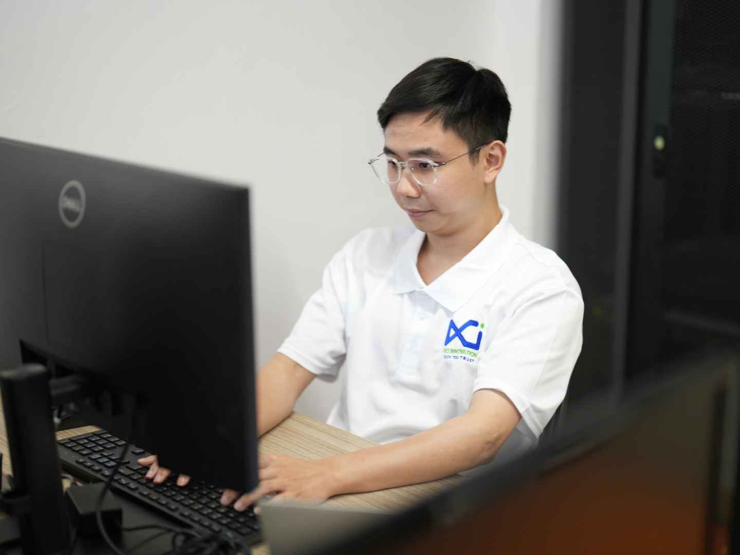 Security consultant reviewing system vulnerabilities and threat protection protocols on a computer