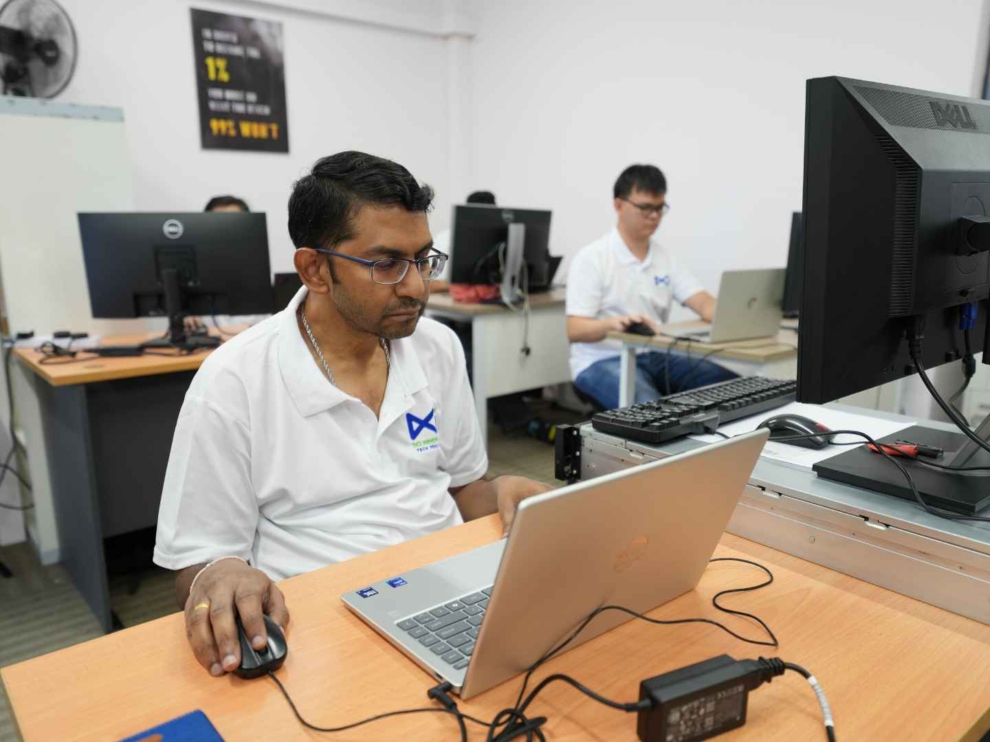 Software and process automation specialist reviewing automated workflows on dual monitors